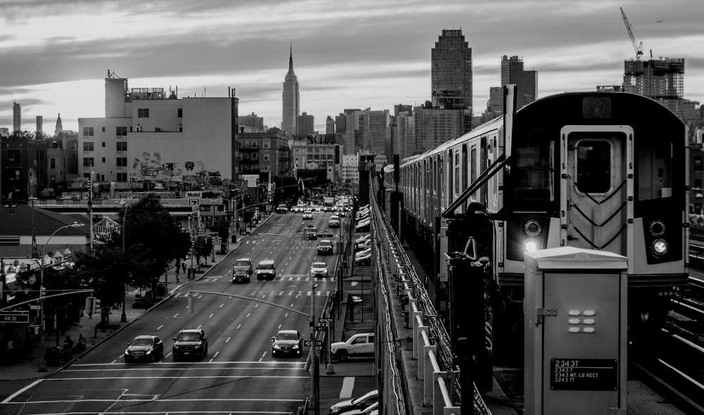 An image of a street in New Jersey with New York visible in the distance