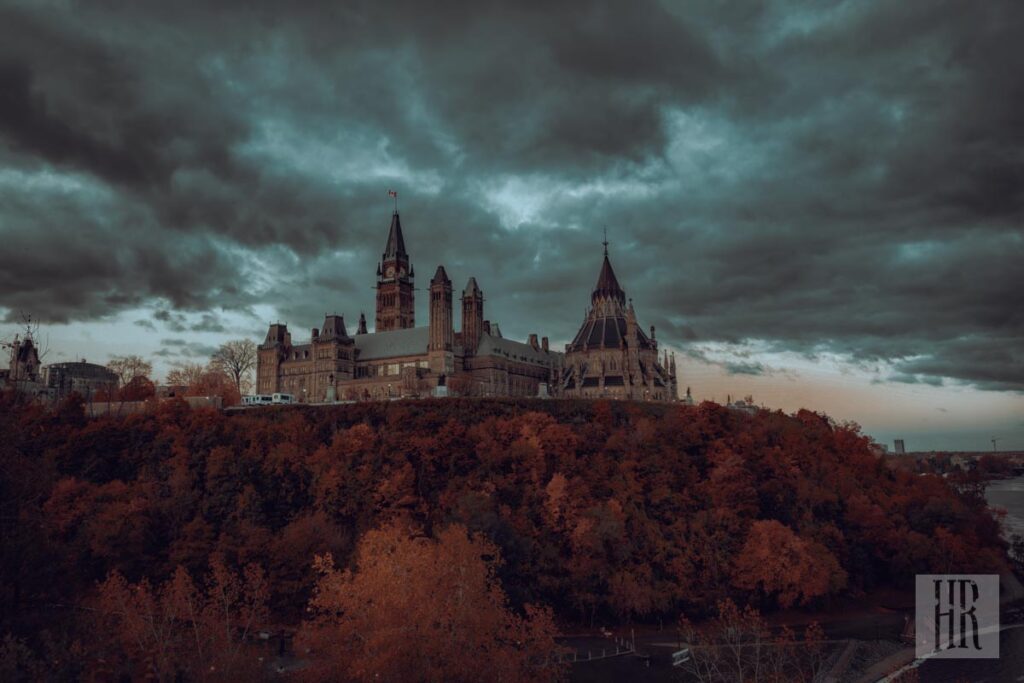 Parliament of Canada buildings under dark cloudy sky