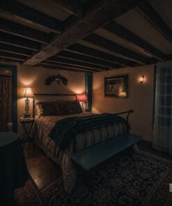 Guest bedroom with heavy ceiling beams at Captain Grant's 1754