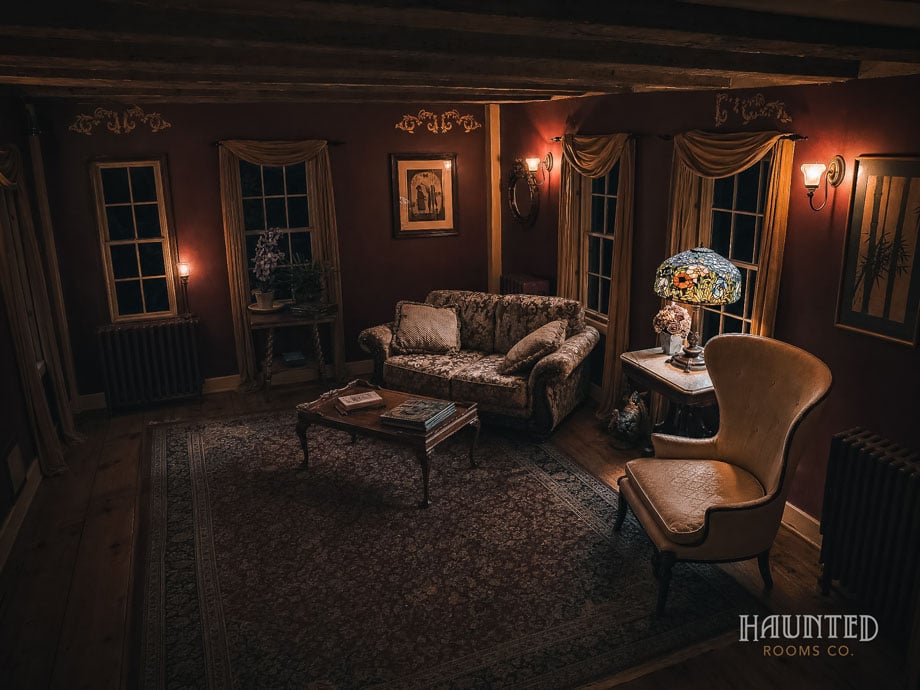 Red sitting room with stained glass lamp at Captain Grant's 1754