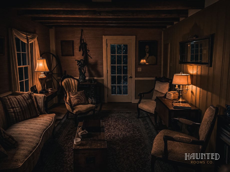Lamp-lit sitting room at Captain Grant's 1754 at night