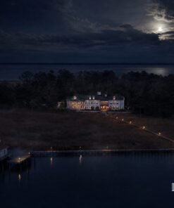 Aerial view over Shallowbag Bay at night toward the Roanoke Island Inn and the lighthouse