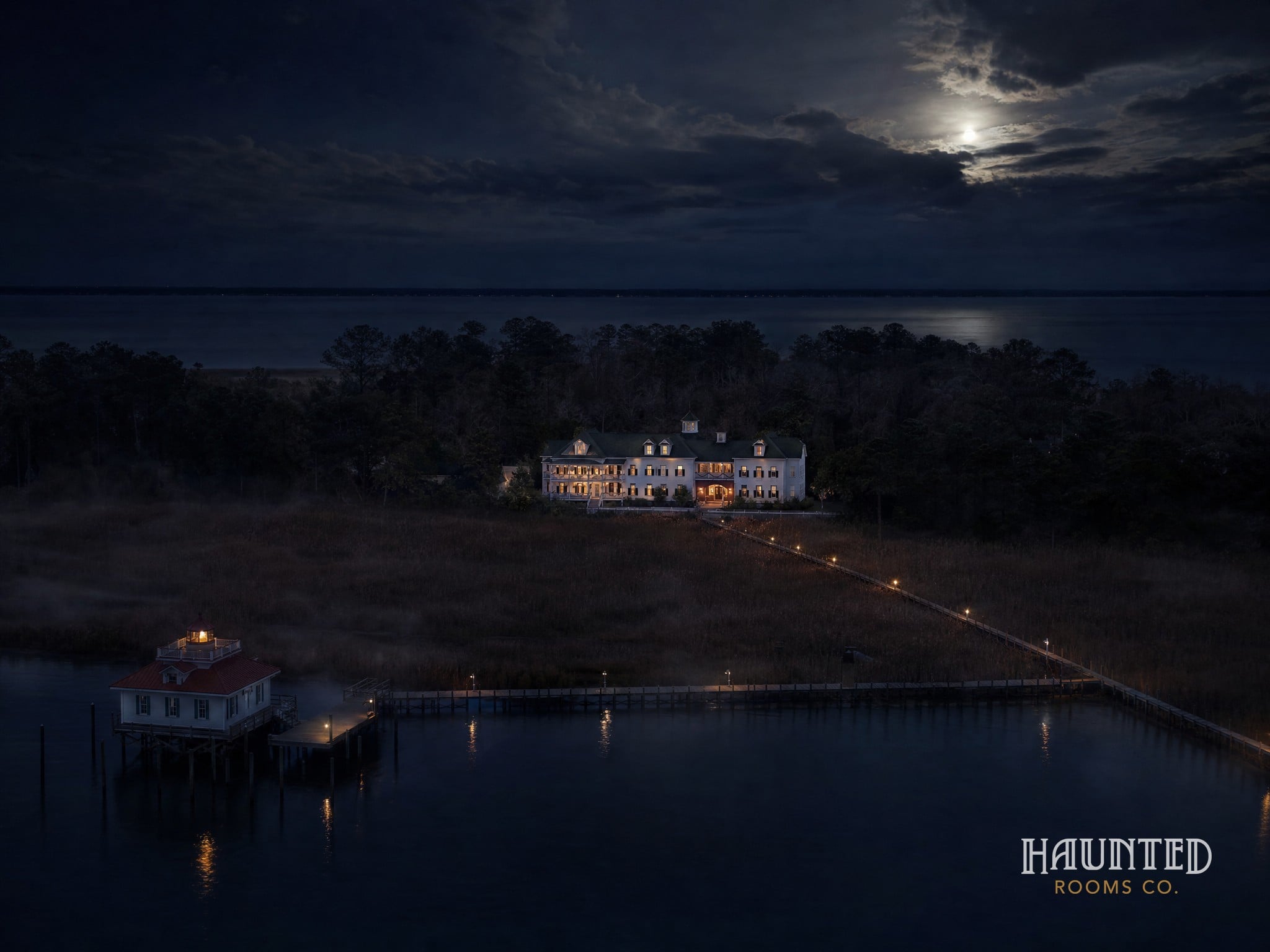 Aerial view over Shallowbag Bay at night toward the Roanoke Island Inn and the lighthouse