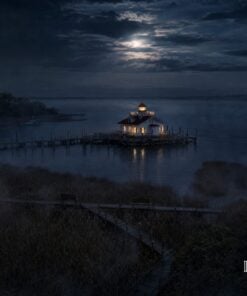 Aerial view of the Roanoke Marshes Lighthouse on the dark water at night, Manteo
